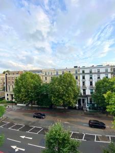 a parking lot in front of a large building at Luxury Studio Kensington London - 24 7 Security in London