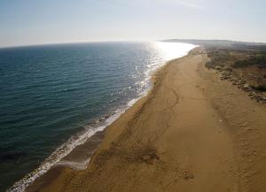 an aerial view of a beach with the ocean at Jabia Beach House in Marinella di Selinunte