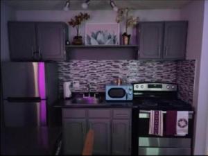 a kitchen with a stove and a microwave at Staycation near Flamingo road in Las Vegas