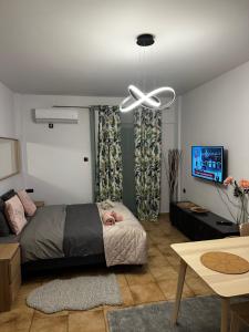 a bedroom with a bed and a ceiling fan at Νεάπολη in Larisa