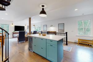 a kitchen with a blue island in the middle of a room at Marble Farm in Waitsfield