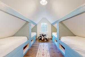 a room with two bunk beds and a window at Marble Farm in Waitsfield