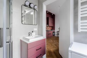 uma casa de banho com um lavatório e um espelho em Very Berry - Kochanowskiego 6/4 - Jeżyce, self check in 24h em Poznań