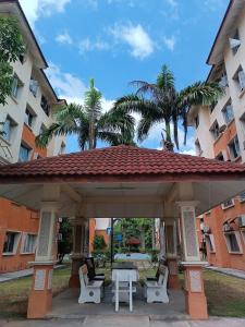 a pavilion with chairs and a table in front of a building at M.FR Homestay Pangsapuri Putra Damai in Putrajaya