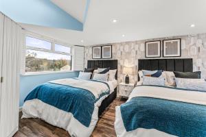 a bedroom with two beds and a window at Expansive Getaway in Cheltenham - Sleeps 15 in Cheltenham