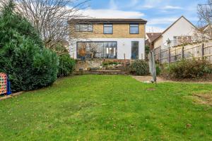 a house with a yard with a fence at Expansive Getaway in Cheltenham - Sleeps 15 in Cheltenham