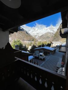 a balcony with a view of a snow covered mountain at coeur di montagna in Courmayeur