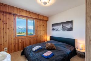 a bedroom with a bed with two towels on it at Chaedoz 21-2 - 4 pers - au calme in Nendaz