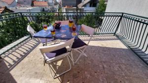 a blue table with chairs and drinks on a balcony at Perlica in Vodice +81 photos