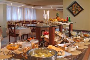 a table with a bunch of food on it at Copas Executive Hotel in Cascavel