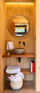 ein Bad mit einem Waschbecken und einem Spiegel in der Unterkunft Outscape Puyehue in Puyehue