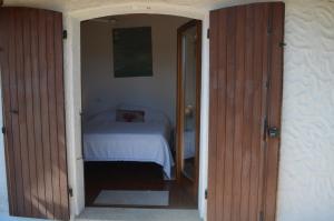 a bedroom with a bed and an open door at Villa Janas in San Teodoro