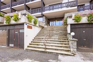 a set of stairs in a building with doors and flowers at Eden Roc 6 - 4 pers - pres des pistes in Nendaz