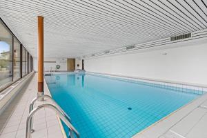 a large swimming pool with a large ceiling at Eden Roc 6 - 4 pers - pres des pistes in Nendaz