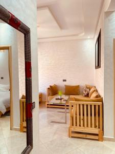 a living room with a couch and a mirror at WOW beach house in Imsouane