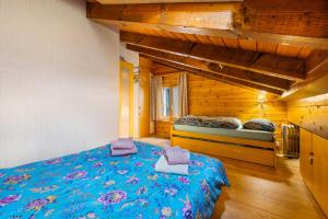 1 dormitorio con 1 cama azul en una casa de madera en Les Hauts-de-Nendaz A C5 - 5 pers - pres des piste, en Nendaz