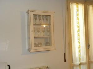a cabinet with glasses in it on a wall at Bright apt with views and terrace in Florence