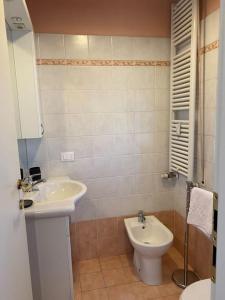 a bathroom with a sink and a toilet at Bright apt with views and terrace in Florence