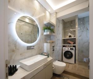 a bathroom with a sink and a washing machine at Sam Casa Luxury Living in Kastoria +10 photos