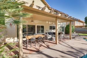 a patio with a wooden table and chairs at Stunning Tempe Home with Pool - Near ASU Campus! in Tempe
