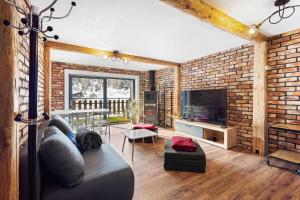 a living room with a brick wall at Dents-Rousses D2 - 4 pers - Siviez in Siviez