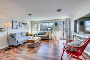 a living room with a couch and a table at Badgers Island Condo Near Restaurants and Marina! in Kittery