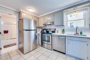 a kitchen with a stainless steel refrigerator and a sink at Badgers Island Condo Near Restaurants and Marina! in Kittery