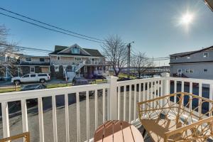 a balcony with a white fence and a chair at Badgers Island Condo Near Restaurants and Marina! in Kittery