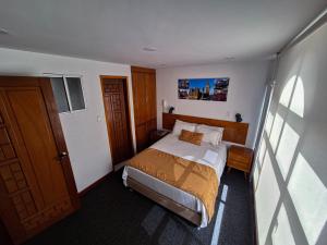 Postel nebo postele na pokoji v ubytování Hotel Estación Sabana