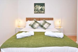 a bedroom with a large bed with two pillows at Chapel House, Where Comfort Meets Convenience - BOOK NOW! in Sandbach