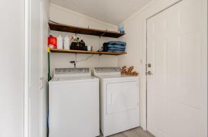 a kitchen with a washer and dryer in a room at Modern Cozy Waterfront Cottage with Fireplace in Livingston Manor