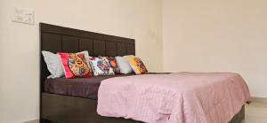 uma cama com almofadas coloridas num quarto em Anshi Home Stay em Varanasi