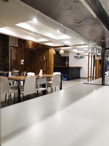 a dining room with a table and white chairs at VILLAGE PARK in Tandil
