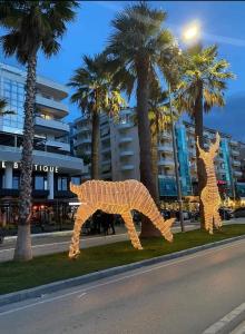 duas estátuas de girafa ao lado de uma rua em Seaview em Vlorë