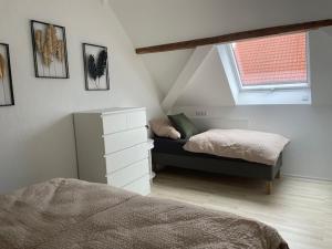 a bedroom with a bed and a window at FREIGEIST ZeitRaum in Haßloch