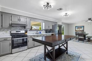 a large kitchen with a wooden table in it at Cozy 3 Bedroom Home in Lake Charles