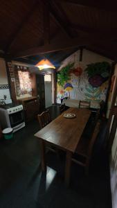 a kitchen with a wooden table in a room at Hakuna Matata in Santa Rosa de Calamuchita