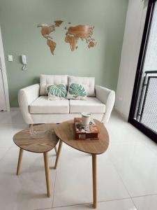 a living room with a couch and a coffee table at Acogedor departamento! in Luque