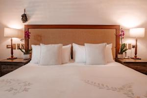 a bedroom with a large bed with white pillows at Amarla Boutique Hotel Cartagena in Cartagena de Indias