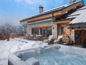 a house with a hot tub in the snow at Chalet Méribel, 6 pièces, 10 personnes - FR-1-566-56 in Les Allues