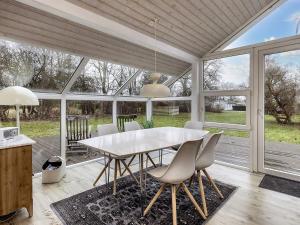 een eetkamer met een witte tafel en stoelen bij Holiday home Karrebæksminde XXXIX in Karrebæksminde