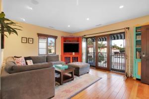 a living room with a couch and a tv at West Beach Villa 6 in Santa Barbara