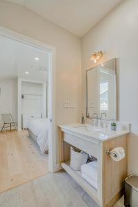 a bathroom with a sink and a mirror and a bed at Villa Castillo 5 in Santa Barbara