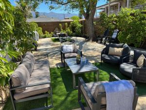 a patio with couches and a table and chairs at Villa Castillo 5 in Santa Barbara