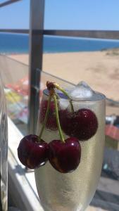 two cherries sitting in a glass of water at Apartment Crystal Beach in Nesebar