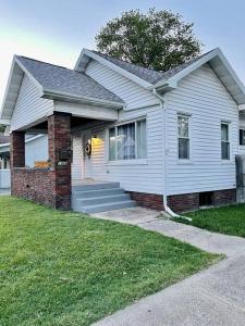 a white house with a red brick at The Chic Shack / Centrally Located 2BR/1BA Home in Evansville