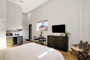 a bedroom with a bed and a tv on a wall at Villa Castillo 3 in Santa Barbara