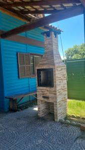 un camino in mattoni di fronte a una casa blu di Chalé Carvalho - Azul a Itapoa Altre 5 foto