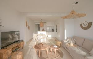 a living room with a couch and two tables at Coco Calpe in Calpe