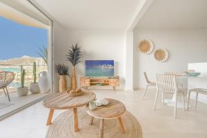 a living room with a table and a dining room at Coco Calpe in Calpe